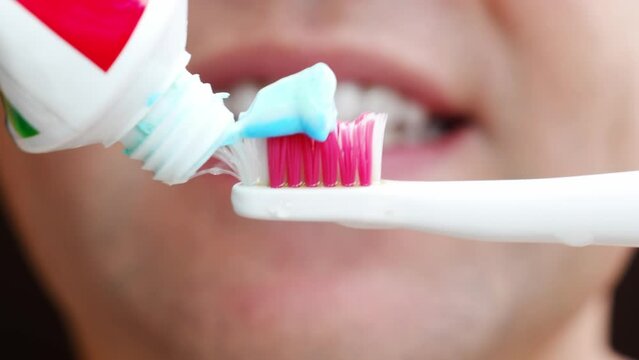 a man's mouth close-up. a man brush your teeth with toothbrush and toothpaste. concept of hygiene and health of teeth and oral cavity. daily care and brushing of teeth.