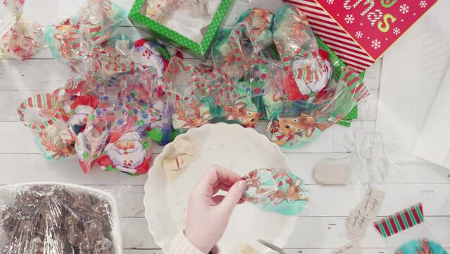 Flat lay. Step by step. Packaging homemade candy cane fudge into small gift bags.