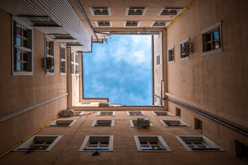 Inner block of old house, upright view, blue skies