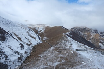 Georgian mountains. Kazbegi. Snow hills, epic clouds