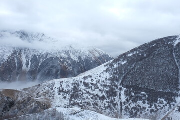 Georgian mountains. Kazbegi. Snow hills, epic clouds