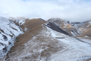 Georgian mountains. Kazbegi. Snow hills, epic clouds