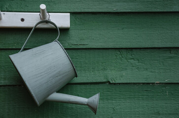 small watering can hanging on the hook, there is a place to record