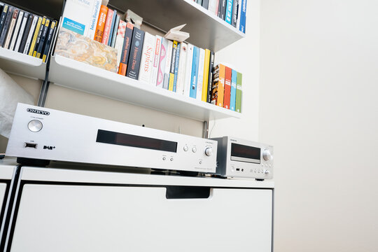 Paris, France - Dec 13, 2022: Low angle view of Onkyo NS-6170 network audio player with DSD Hi-Res Audio and DSD DAB WIFI device next to CR-N755 network player