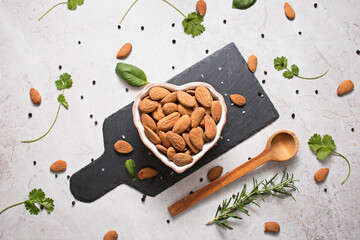 Almond nuts in heart shaped bowl