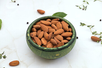 Almond nuts in green bowl