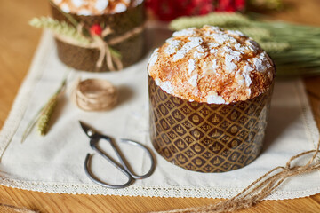 Easter cake with rustic decoration, wheat on wooden table the holiday