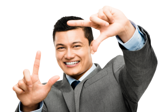 An asian businessman framing his face using his fingers isolated on a PNG background.
