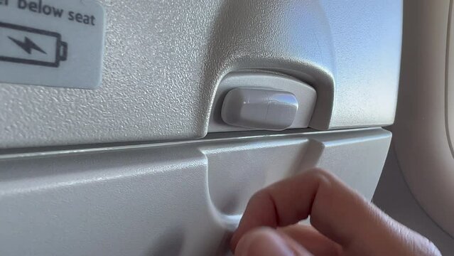 Closeup hand opening and closing plane tray table
