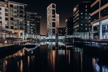 Fototapeta na wymiar The Dock in Leeds, view of the night city skyscrapers 