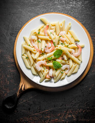 Pasta with shrimp and mint leaves.