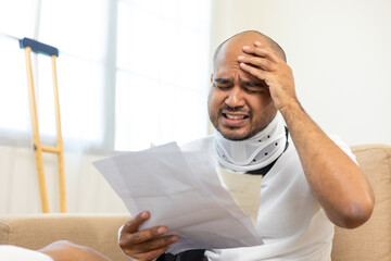 UnHappy man stressed pay invoice medical expenses from accident fracture broken bone injury with...