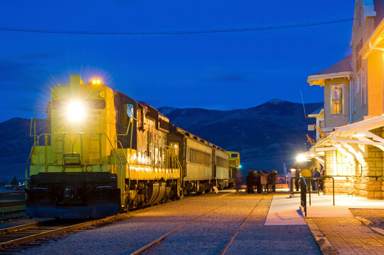 People load onto a diesel train at the Nevada Northern Railway at dusk in Ely, Nevada.