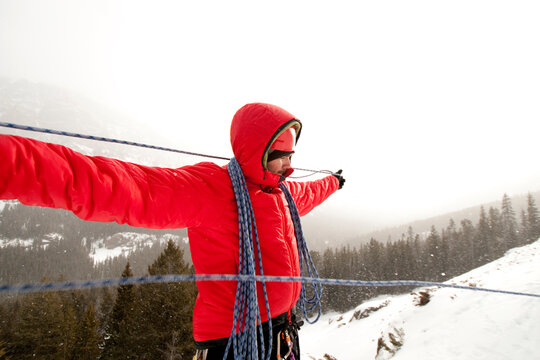 A man flaking rope after a day of ice climbing.