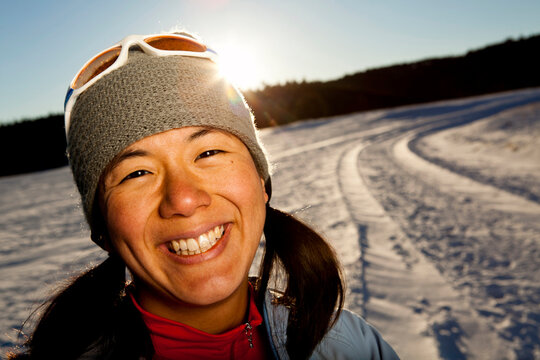 a Japanese-American woman has her portrait taken after running down a snowy road in Custer State, South Dakota.