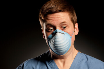 Studio portrait of a 24 years old Caucasian man wearing a protective mask.