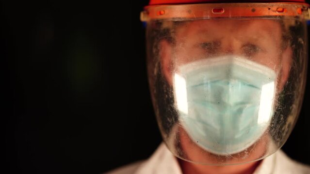 Australian person putting on safety equipment and a mask in a workplace in an industry