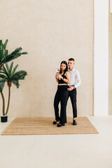 Young couple girl and boy in the studio modern lifestyle portrait. Love and relationship