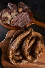 Smoked pork and sausage on wooden board