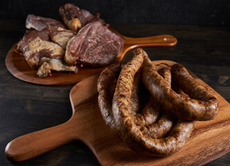 Smoked pork and sausage on wooden board