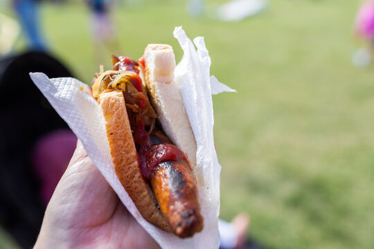 Classic summer event food of sausage in white bread and serviette