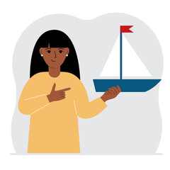 A woman holds a sailing yacht in his hand. Concepts of freedom, hope and big plans. Hobby, sport or business.