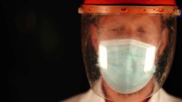 Australian person putting on safety equipment and a mask in a workplace in an industry
