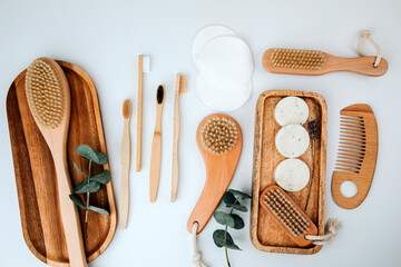 Set of wooden eco friendly devices. Brushes, washcloth and ear sticks, natural soap, textile bags on a white background. Flat lay