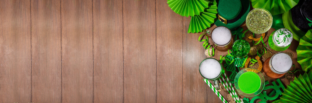 St Patrick's Day bar menu background. Set various golden, green beer glasses, different cocktails and drinks, with St. Patrick's Day party decor and accessories, on dark wooden background