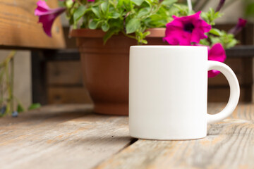 White mug in the garden. - 562098711