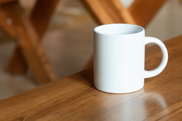 White mug on the wooden table.