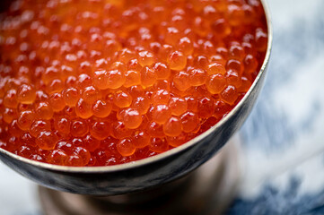Bowl full of red caviar. Close view.