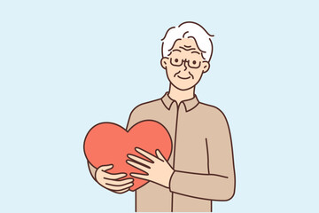 Smiling mature man hold big heart in hands 