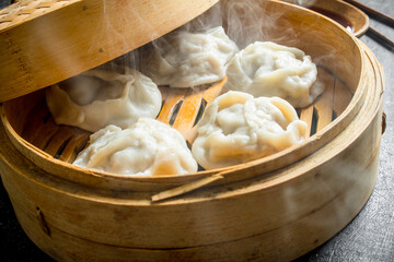 Hot dumplings manta in a bamboo steamer.