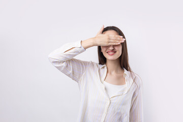 Portrait of a serious young woman showing stop gesture with her palm over white background