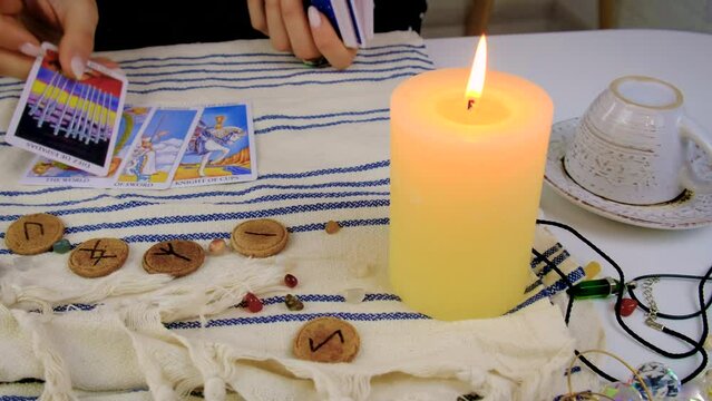 Fortune teller woman reads tarot cards. Selective focus.