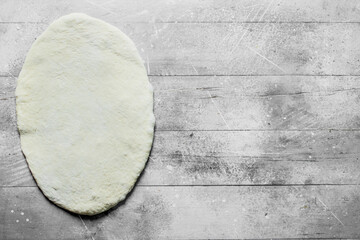 Round rolled dough for homemade pizza.