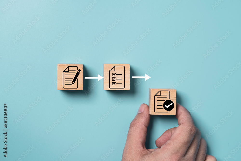 Aufkleber Hand arrange document which print screen on wooden cube block for prepare check and approve document , Quality assurance and ISO guarantee concept.