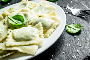 Ravioli with spinach leaves.