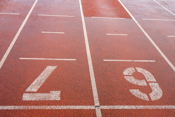running track with numbers in the rain