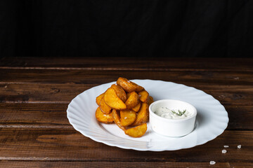 French fries on a white plate on a wooden table