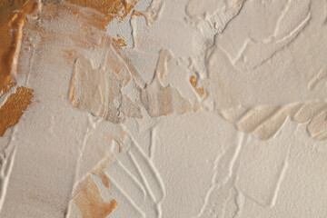 Stucco oil and acrylic smear blot canvas painting wall. Abstract texture pastel gold, beige color stain brushstroke texture background.