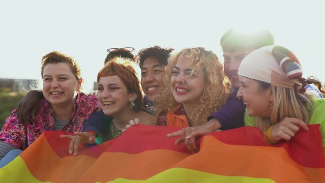 Group of happy young people having fun together during LGBT pride parade