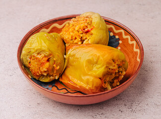 Green peppers stuffed with rice on bowl