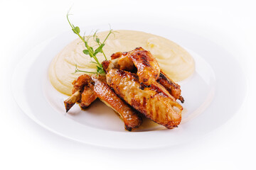 Fried chicken wings and mashed potatoes on plate