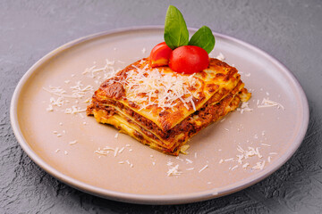 Traditional lasagna with bolognese sauce topped
