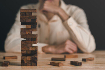 A wooden jenga box placed on the table,Financial risk management and strategic planning through...