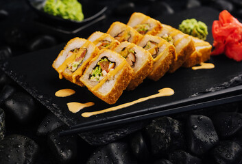 Warm sushi roll with poured cheese sauce