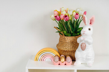 Spring flowers, Easter Bunny and eggs. Home interior with easter decor.   Children's room in the Easter style. Holidays decorations.