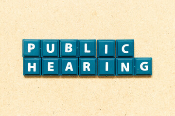 Tile alphabet letter in word public hearing on wood background